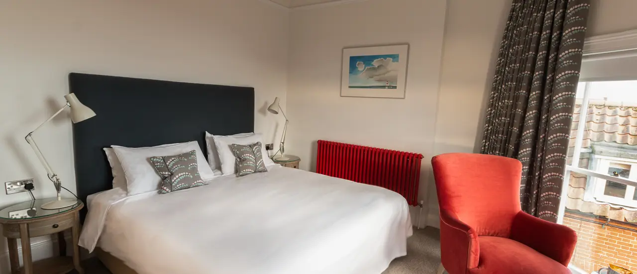 Deluxe Sea View room, bed with comfy chairs