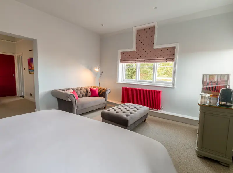 Deluxe town room, lower end of bedroom, sofa and foot pouffe