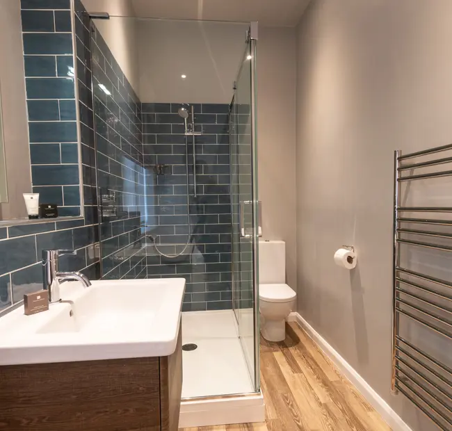 Deluxe town room, bathroom, showing walk in shower and sink