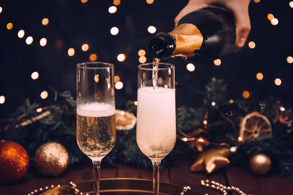 Pouring Champagne into glasses on the bar